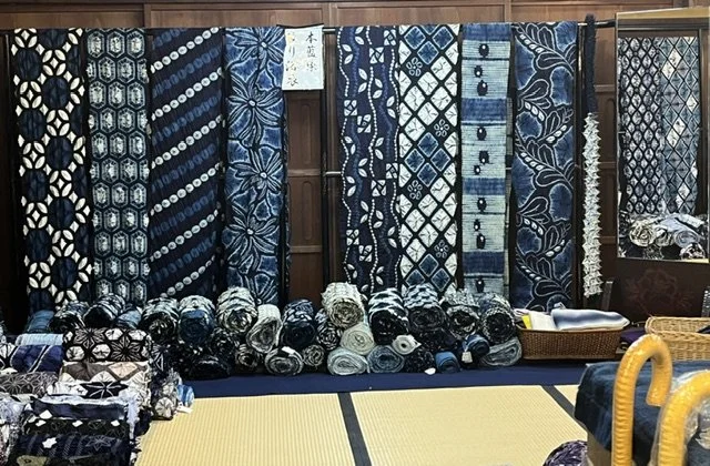 Indigo and shibori textiles displayed in a Japanese shop