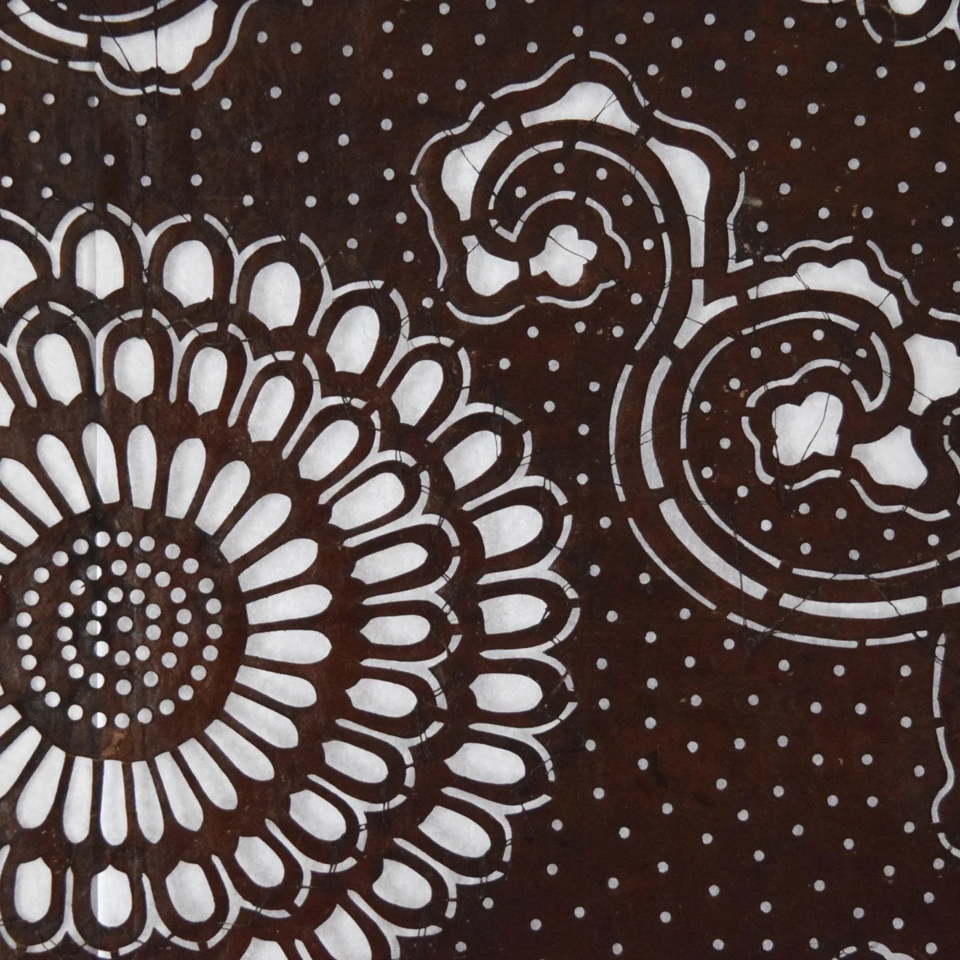 Katagami stencil with white chrysanthemum motifs on brown paper